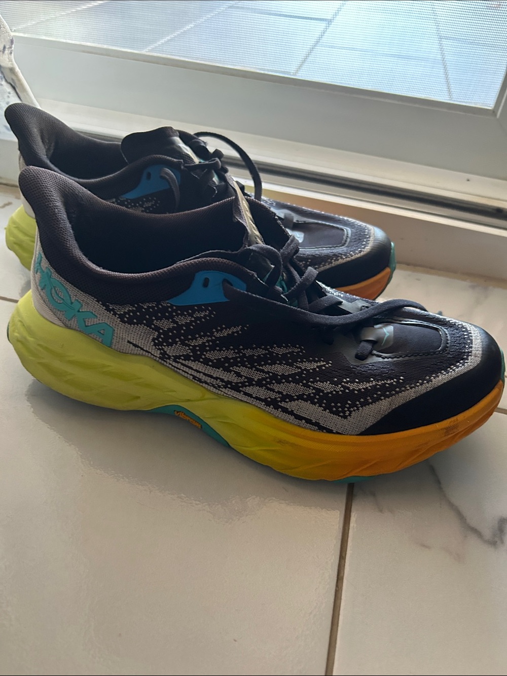 Hoka Black Running women Shoe with Blue Logo and Yellow Insole Accent.8.5B